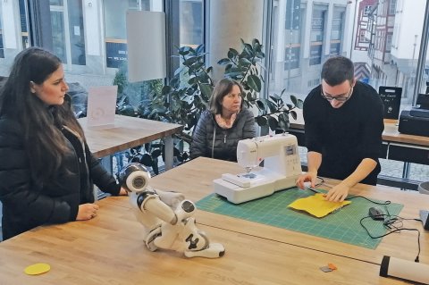Im Maker Space im EG der Stadtbibliothek wird einer Gruppe eine Nähmaschine vorgestellt. Foto: Petra Schmitz